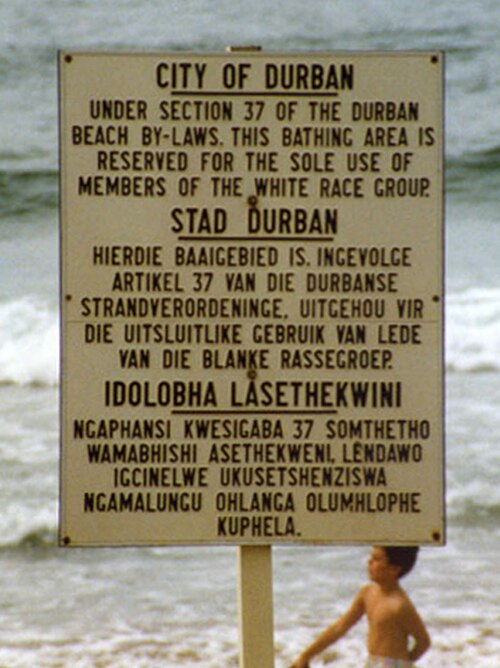 A sign on a Durban beach in 1989 delineates space by race, a mundane yet potent symbol of the apartheid system's logic of total segregation.