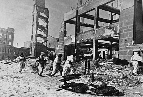 Soviet soldiers amidst the rubble of Stalingrad. The scale of eastern continental violence paralleled demographic devastation across non-European theatres.